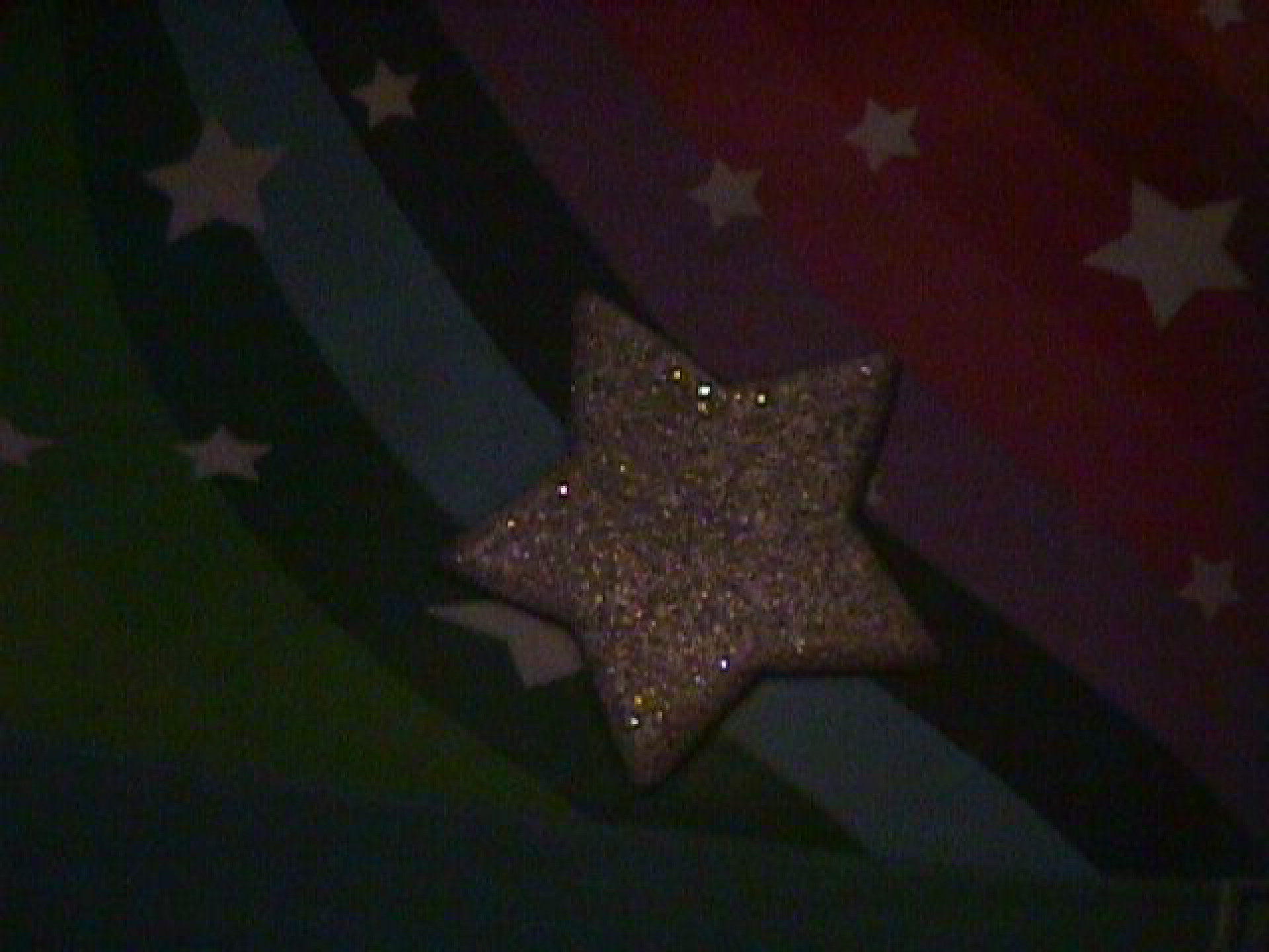 Rainbow sparkles and a star on the side of a rain boot